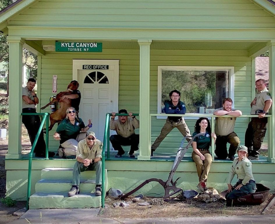 Park rangers in front of a hut who receive funding from public donations.